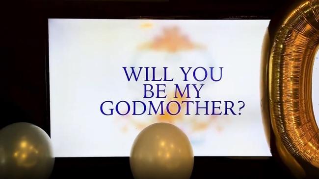 A screen displayed a question for the radio host, ‘Will you be my godmother?’ Picture: Instagram/kyleandjackieo