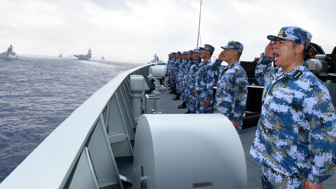 A PLA navy fleet including the aircraft carrier Liaoning, submarines, vessels and fighter jets take part in a review in the South China Sea. Picture: Getty