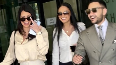 Blues (left) smiled as she left the courthouse.