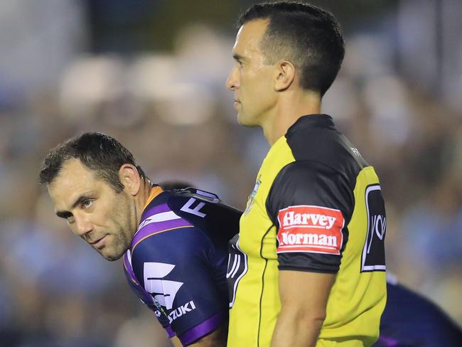 Cameron Smith looks on next to referee Matt Cecchin after Cronulla were awarded a penalty.