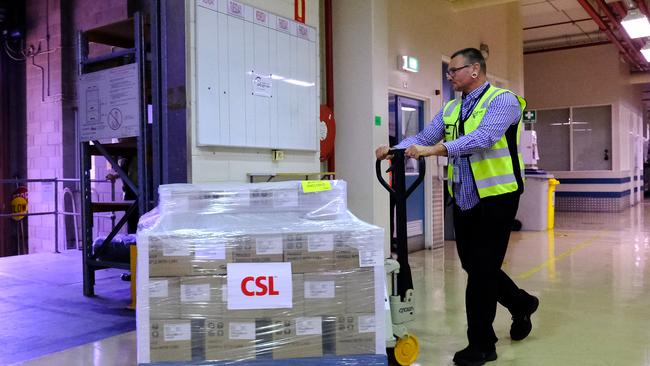 Workers at CSL roll out onto a truck the first batch of the AstraZeneca produced by CSL in Australia on Wednesday. Picture: Luis Ascui/Getty Images