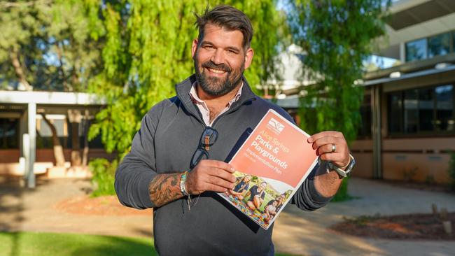 Alice Springs Town Council Mayor Matt Paterson holds the council's latest parks and playgrounds implementation plan, May 2025. Picture: Alice Springs Town Council