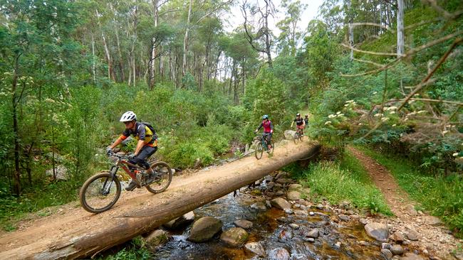 Crossing the Delatite River by mountain bike in the Victorian Alps.