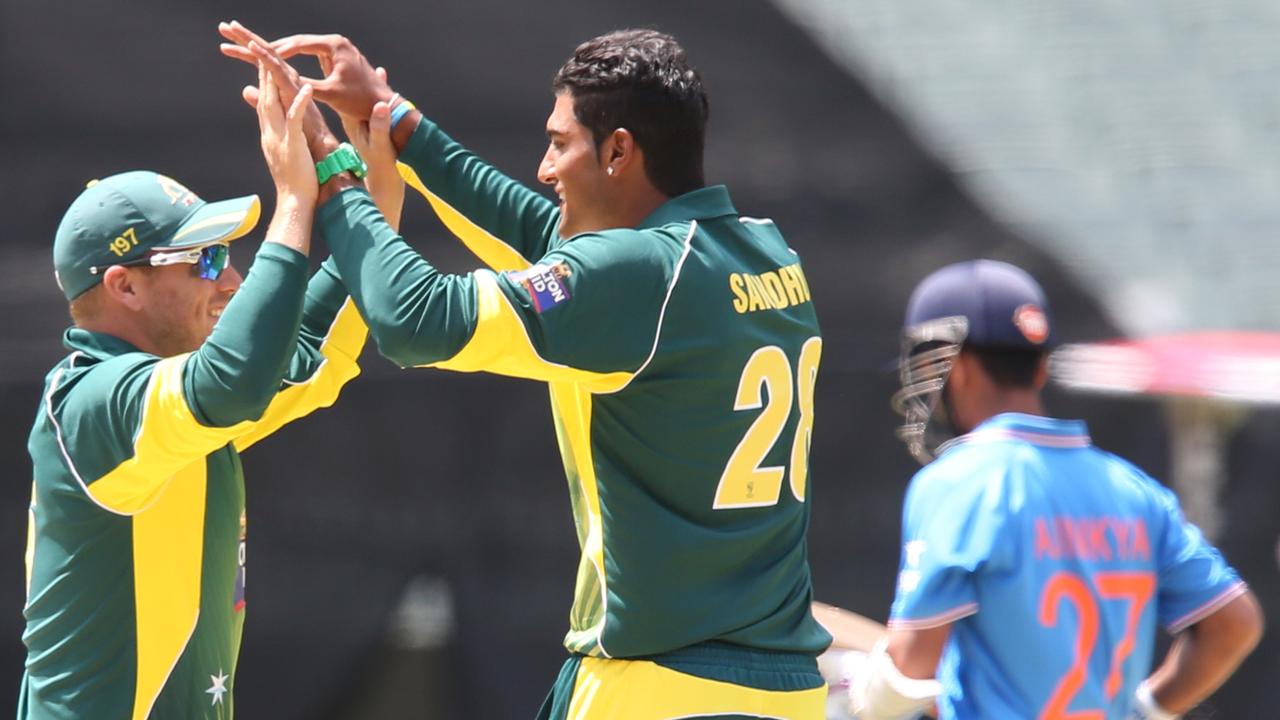 Gurinder Sandhu celebrates his first ODI wicket of Indian batter Ajinkya Rahane with Aaron Finch (left) at the MCG in January 2015. Picture: David Crosling / AAP