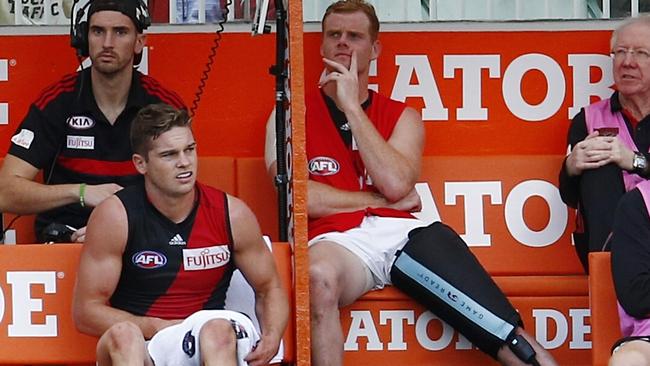 This injury is hard to hide. Adam Cooney gets treatment on the bench after hurting his hamstring. Picture: Michael Klein