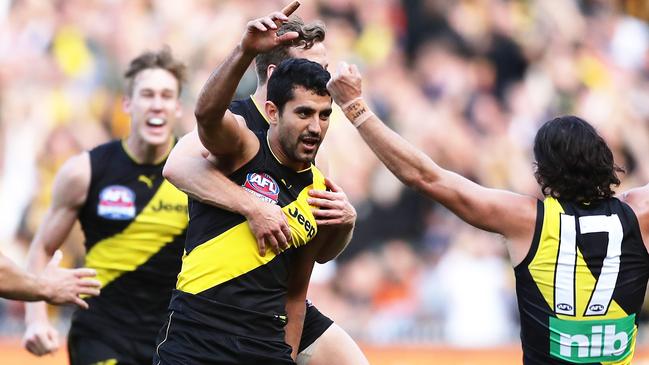 MELBOURNE, AUSTRALIA - SEPTEMBER 28: Marlion Pickett of the Tigers celebrates with team mates after kicking a goal during the 2019 AFL Grand Final match between the Richmond Tigers and the Greater Western Sydney Giants at Melbourne Cricket Ground on September 28, 2019 in Melbourne, Australia. (Photo by Matt King/AFL Photos/via Getty Images )