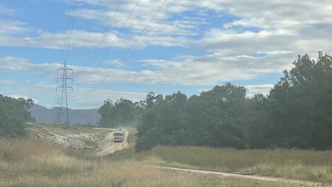 Firefighters leave the scene of a fatal incident near Lake Proserpine, where a man fell 20m before succumbing to his injuries. Picture: Estelle Sanchez