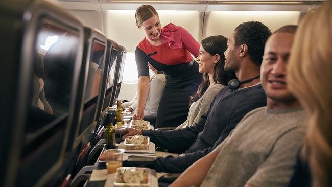 From Jan 20, Qantas will be offering direct seasonal flights from Sydney to Sapporo’s New Chitose Airport, to help make it easier for travellers to reach Hokkaido’s world-class ski resorts on Japan's northernmost island. Picture: Supplied/Qantas.    Inflight economy cabin passengers are getting food served in Qantas A330