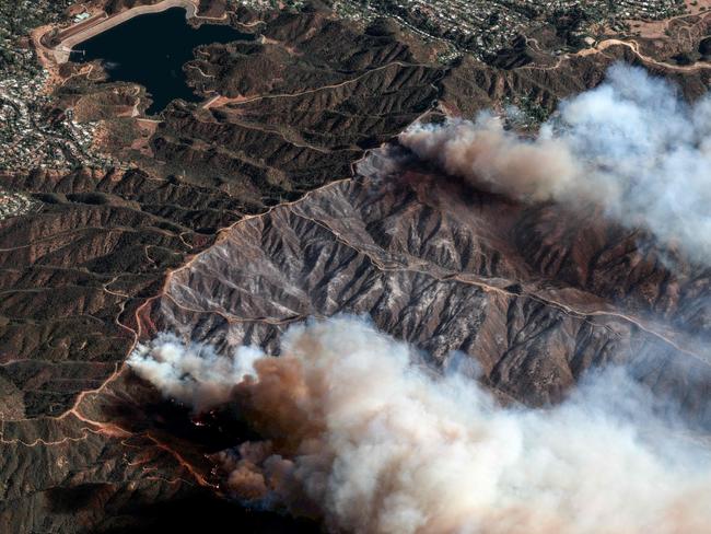 TOPSHOT - This satellite image taken and released by Maxar Technologies on January 11, 2025 shows an overview of the Palisades Fire as it continues to burn in the mountains north of Santa Monica, California, with the Encino Reservoir in the distance (L). The Palisades Fire, the largest of the Los Angeles fires, spread toward previously untouched neighborhoods January 11, forcing new evacuations and dimming hopes that the disaster was coming under control. Across the city, at least 11 people have died as multiple fires have ripped through residential areas since January 7, razing thousands of homes in destruction that US President Joe Biden likened to a "war scene." (Photo by Satellite image Â©2025 Maxar Technologies / AFP) / RESTRICTED TO EDITORIAL USE - MANDATORY CREDIT "AFP PHOTO/ SATELLITE IMAGE Â©2025 MAXAR TECHNOLOGIES" - NO MARKETING NO ADVERTISING CAMPAIGNS - DISTRIBUTED AS A SERVICE TO CLIENTS - THE WATERMARK MAY NOT BE REMOVED/CROPPED