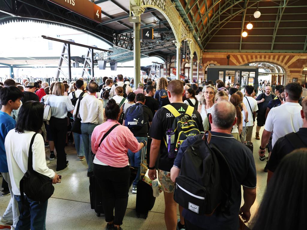 Delayed Passengers attempt to board the train to Newcastle from Central Station. Picture: Ted Lamb