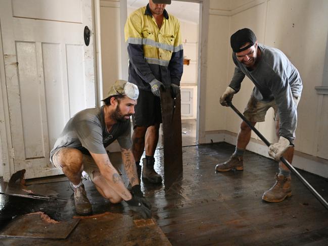 Max Moon removes flood damaged flooring in a rental property that he owns in Lismore on March 3 last year. Picture: Dan Peled