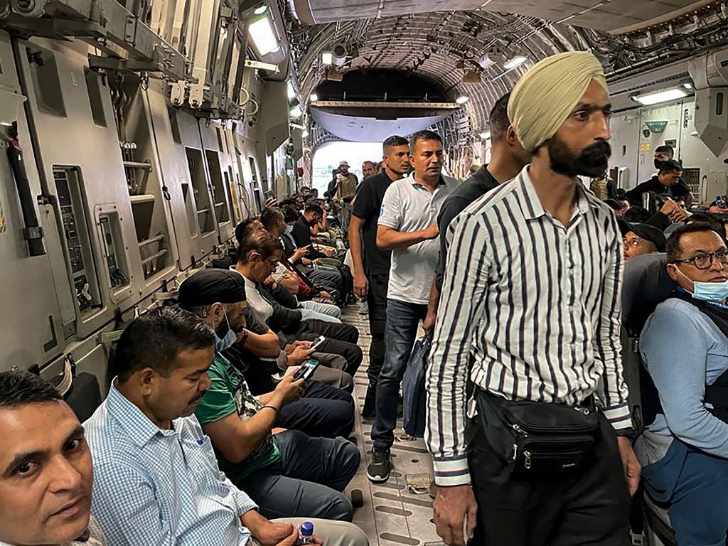 Indian Nationals sit aboard an Indian military aircraft at the airport in Kabul on August 17 to be evacuated. Picture: AFP