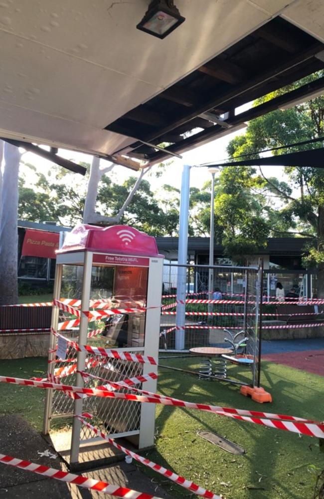 Northern Beaches Council taped off a children's playground, and telephone box, at the Killarney Heights shopping precinct. There were concerns of fragments of asbestos sheeting from a shop awning may still be present. Picture: Jim O’Rourke