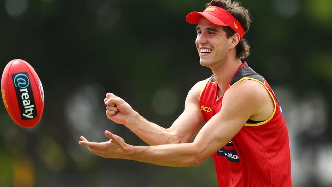 Ben King handballs during a Gold Coast Suns AFL training session.