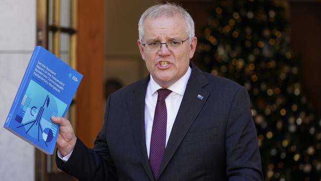 Scott Morrison holds the Jenkins report at Parliament House. Picture: Adam Taylor