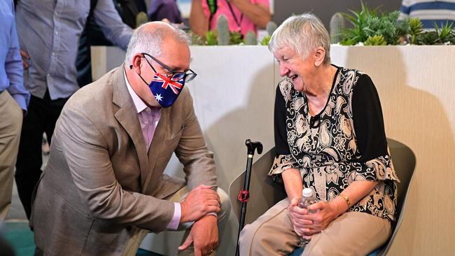 Prime Minister Scott Morrison speaks to 84-year-old Jane Malysiak, who became the first person in Australia to receive a dose of the Pfizer/BioNTech COVID-19 vaccine, at the Castle Hill Medical Centre in Sydney on Sunday. (Photo by Steven SAPHORE / AFP)