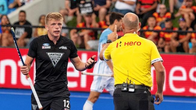 Ipswich international hockey umpire Steve Rogers controlling play during a Pro League match.