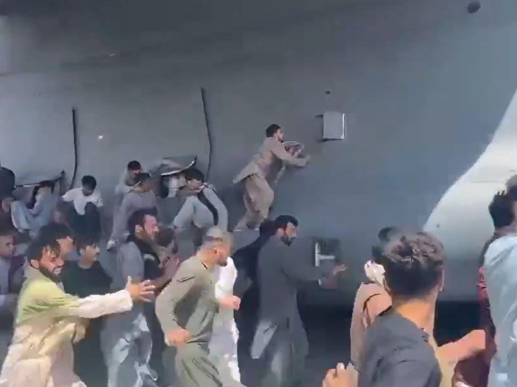 Footage shows what appears to be young Afghan men attempting to stowaway.