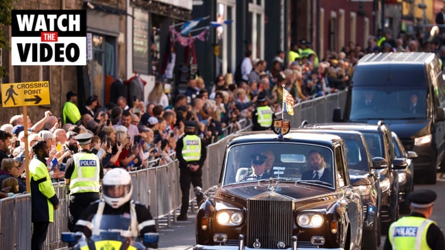 Mourners queue to walk by Queen's coffin, meet King Charles III