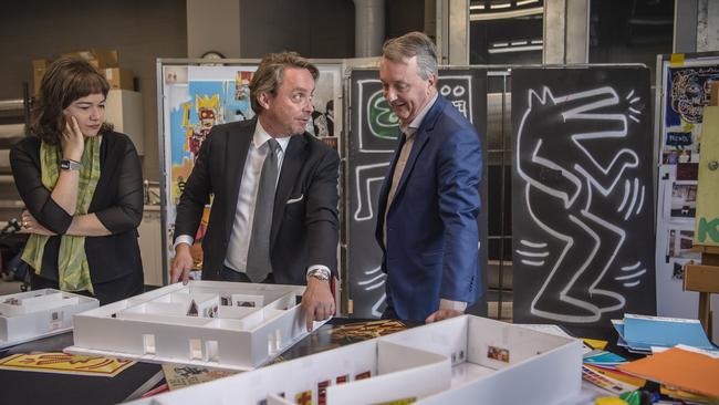 NGV director Tony Ellwood and Arts Minister Martin Foley with the original door from Keith Haring’s famed mural in Collingwood, which will feature in the Keith Haring | Jean-Michel Basquiat: Crossing Lines exhibition. Picture: Supplied