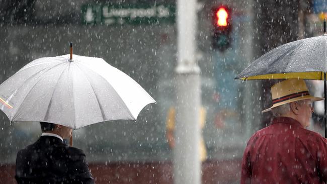 Commuters in Sydney’s CBD are soaked by rain, and it’s only going to get worse. Picture: NCA NewsWire / Damian Shaw