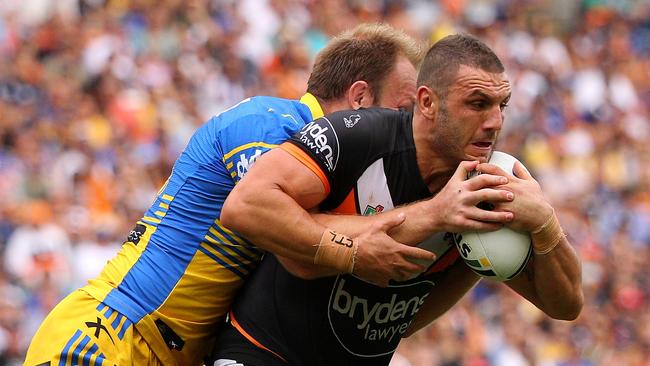 SYDNEY, NEW SOUTH WALES - MARCH 28: Robbie Farah of the Tigers is tackled during the round four NRL match between the Wests Tigers and the Parramatta Eels at ANZ Stadium on March 28, 2016 in Sydney, Australia. (Photo by Matt Blyth/Getty Images)