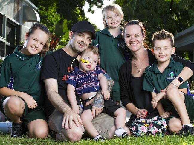 Adam Haevecker and Renee Bell with their 2 year old son Mason, who suffered brain damage after he went into cardiac arrest during heart surgery, and his siblings Paige, 9, Ava, 5, and Addison, 6 at Hummingbird House. Picture: Lachie Millard