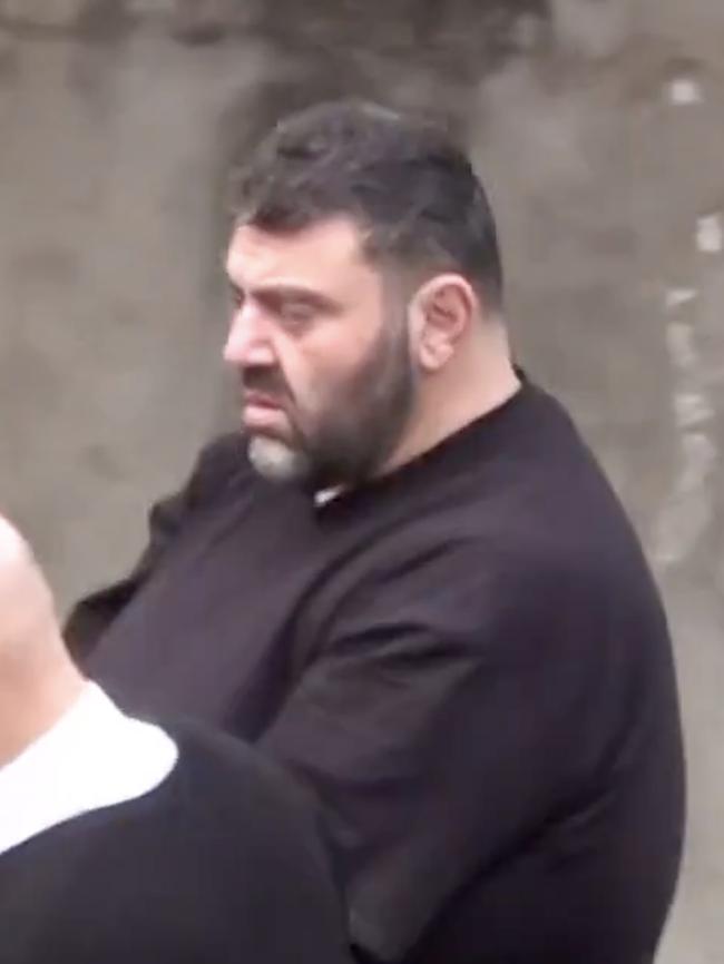 Zenon Joannou is led into Adelaide Magistrates Court on Wednesday. Picture: SAPOL