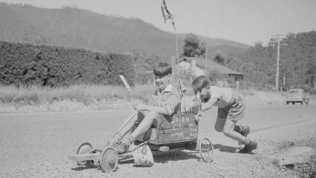 Two boys with their billycart decorated for the 1954 visit of Queen Elizabeth II.