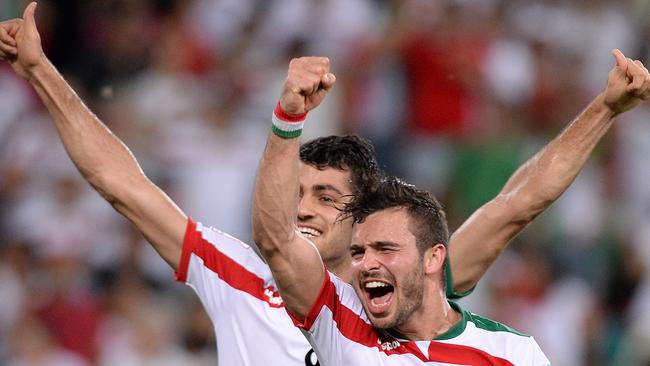 Soroush Rafiei and Morteza Pouraliganji celebrate Iran’s win over the UAE.