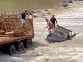 Jaw-dropping footage of two men leaping to safety in the midst of rushing water and hungry crocs at Cahills Crossing has emerged, but one witness said the footage did not come close to portraying the fear onlookers felt.