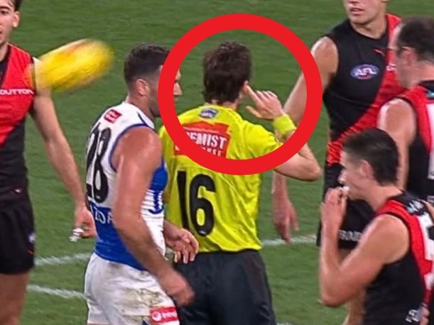 The umpire held his finger to his ear and changed his decision.