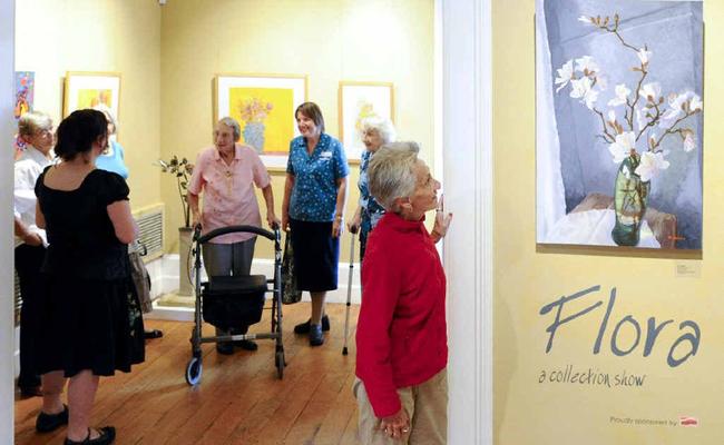 Dougherty Villa resident Elizabeth Duval inspects a painting at the Grafton Regional Gallery as part of Seniors Week. 