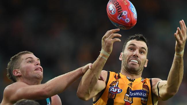 Dan Houston attempts to spoil Jonathon Ceglar of the Hawks. Picture: AAP Image/Julian Smith