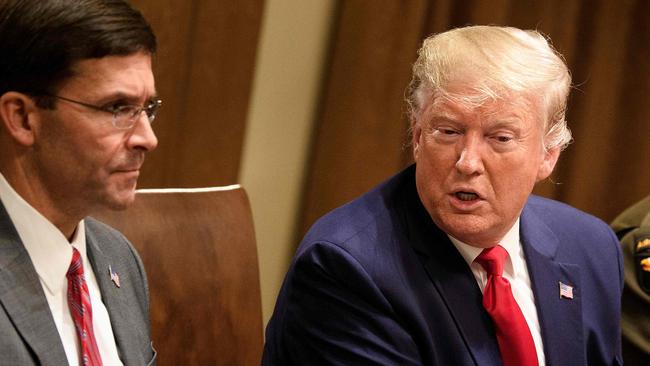 US Defence Secretary Mark Esper (left) meets with Donald Trump and military leaders at the White House in October last year. Picture: AFP