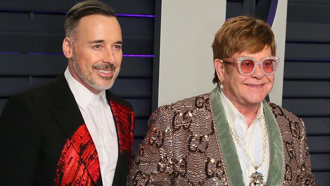 Surrogate parents Elton John, right, with husband David Furnish. Picture: AFP