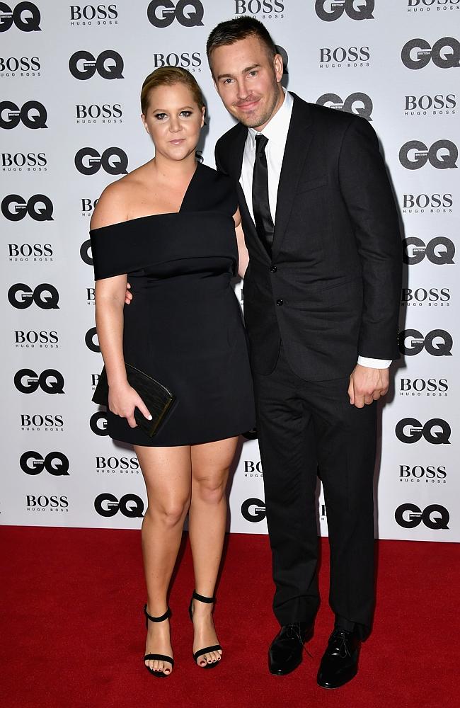 Amy Schumer and Ben Hanisch arrive for GQ Men Of The Year Awards 2016 at Tate Modern on September 6, 2016 in London, England. Picture: Getty