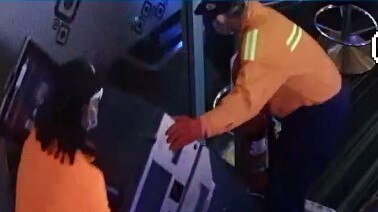 Two of the wannabe tradies help themselves to the cash dispenser. Picture: Supplied.