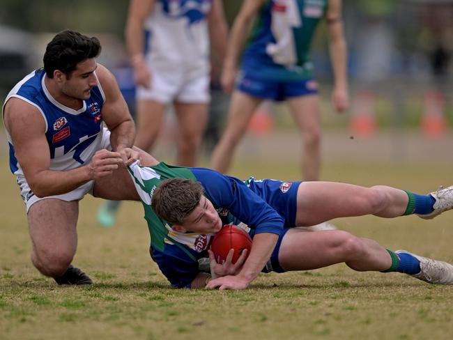 EDFL: Sunbury Kangaroos’ John Corso brings down Joshua Crump of East Sunbury. Picture: Andy Brownbill