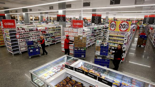 Coles supermarket is opening a new store at Ed.Square in Edmondson Park in Sydney's south west. Employees L-R Zinat Rehana, Jyoti Rayamajhi and Binita Pradhan stock the shelves ready for opening. Picture: Toby Zerna