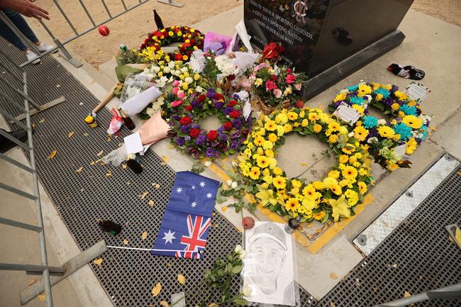 Wreaths laid at the base of the Shane Warne statute outside the MCG. Picture: Jason Edwards