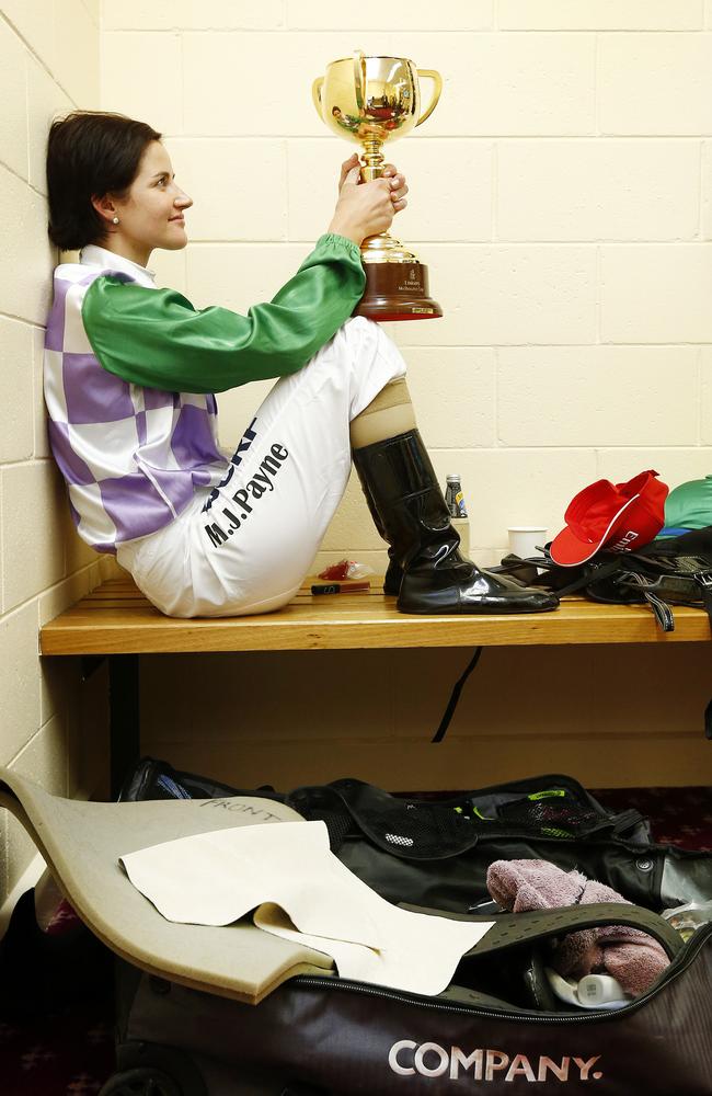 Michelle Payne spends a quiet moment in the jockeys room with the Melbourne Cup after her win on Prince Of Penzance. Picture: Colleen Petch