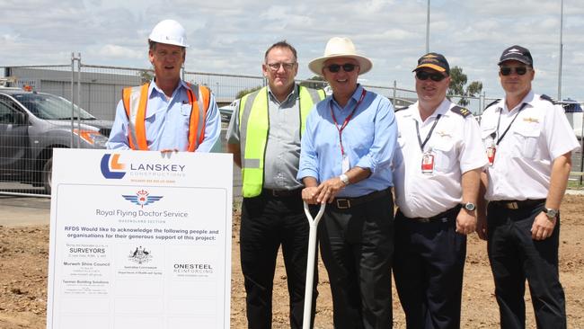 A photo from 2014 of Lanskey Constructions signing on a runway at Roma Airport for anew Royal Flying Doctor Service base. From left to right: The Queensland arm of the company has since gone into liquidation.