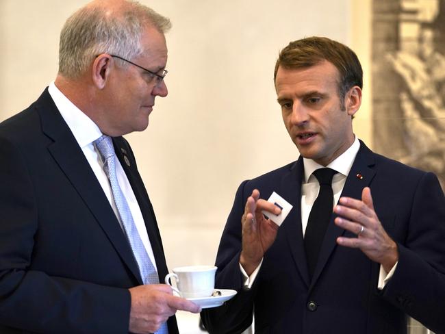 Australian Prime Minister Scott Morrison and French President Emmanuel Macron talk before the G20 leaders make a short visit to the Fontana di Trevi to throw a coin in the fountain to make a wish before the start of the second day of the G20 in Rome on Sunday, October 31, 2021. Picture: Adam Taylor