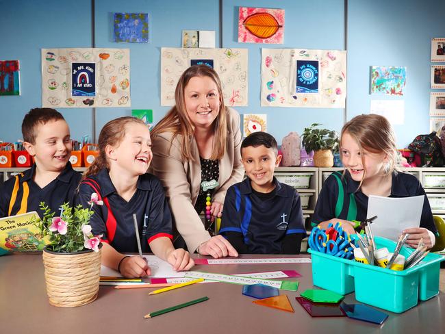 Holy Cross Primary School in New Gisborne has hired teachers and are thriving despite other regional areas struggling to attract teachers. Pictured are students Oscar, Lily, Alma and Noah with their teacher Louise Ralph. Picture: Rebecca Michael