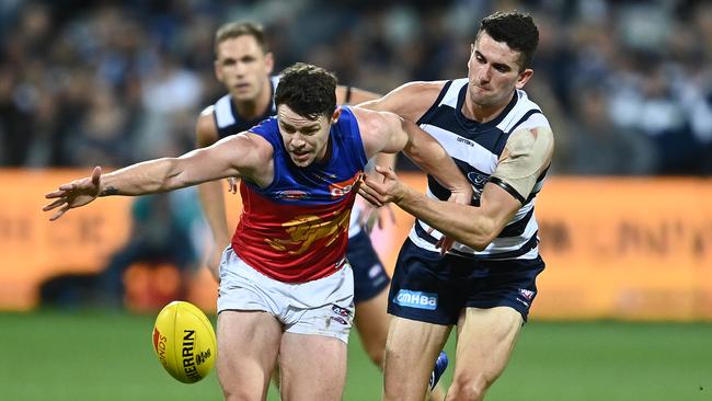 Lachie Neale battles to escape the clutches of Mark O’Connor. Picture: Quinn Rooney/Getty Images