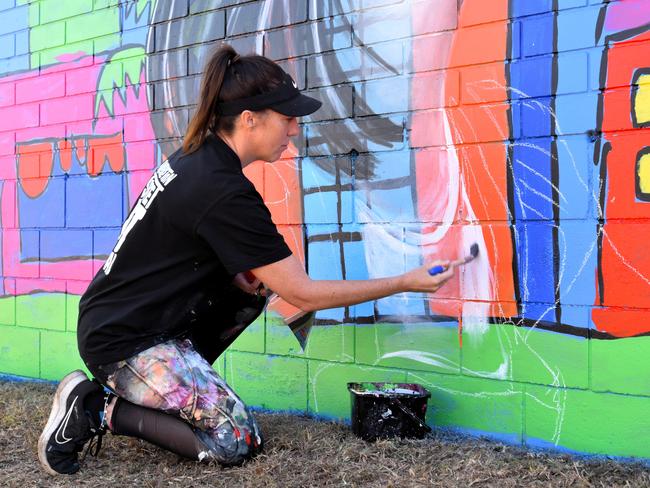 Artist Polly Johnstone - known as Miss Polly - kicks off the first Palmerston Street Art Festival in 2024. Her mural is based on a painting she did as a child, and includes a portrait of her younger self and an amalgamation of her two sons. Picture: Sierra Haigh