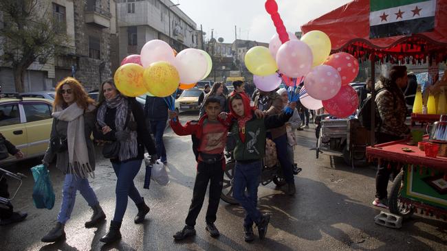 Children pose with balloons at a market on New Year's Eve on December 31, 2024 in Damascus, Syria. Picture: Ali Haj Suleiman/Getty Images