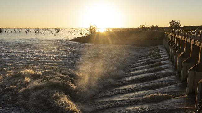 Water flows through the Menindee Lakes main weir on May 17, 2021 in Menindee. Picture: Brook Mitchell/Getty Images