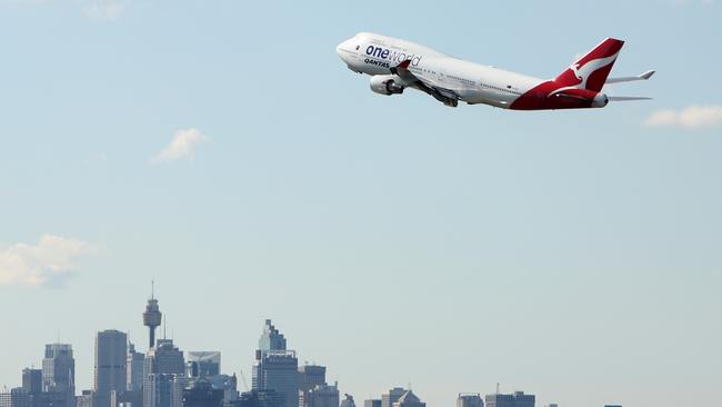 A Qantas plane flying over Sydney. Picture: Chris Pavlich